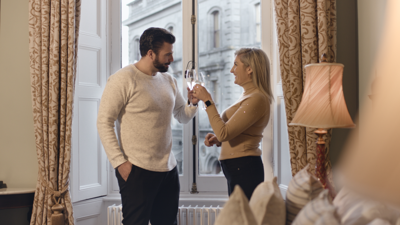 Couple toasting to an Autumn Hotel Break at the Kilkenny Hibernian Hotel